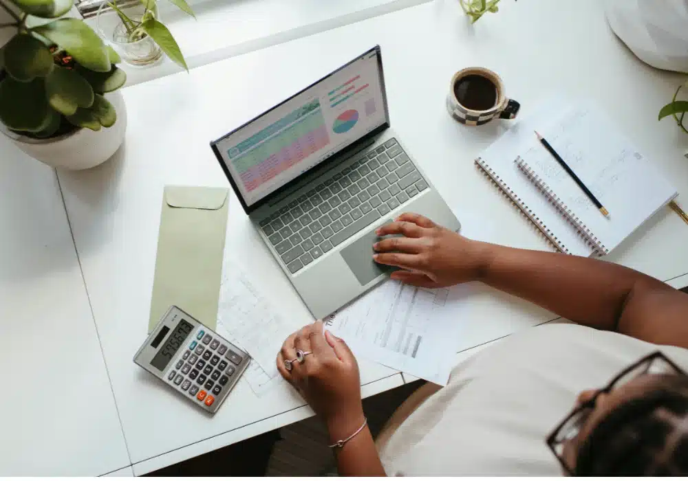 Stay-at-home mom working on passive income side hustle on laptop at home