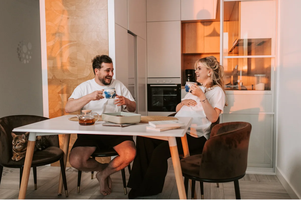 Couple collaborating in a modern home studio managing client contracts and digital appointments