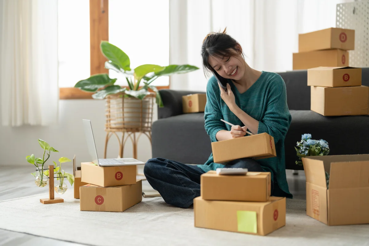 Branded custom e-commerce product boxes stacked neatly on a shipping workstation