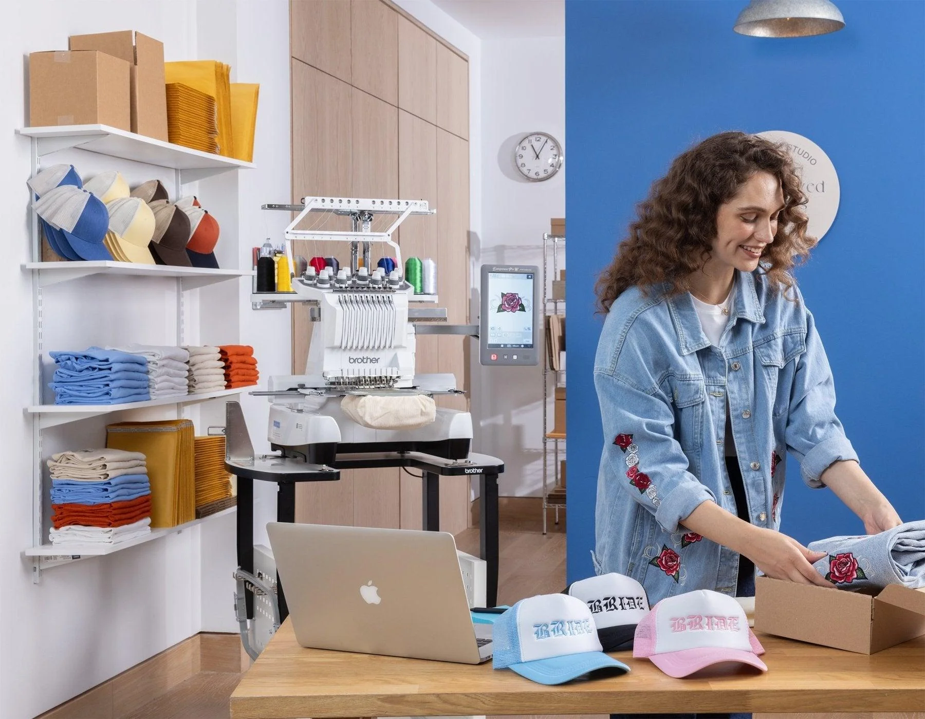 Female business owner setting up heat press machinery and custom apparel in home production studio